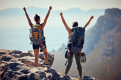 Buy stock photo Hiking, mountain top and backpack women celebrate success, motivation and winning cliff climbing or trekking achievement. People, freedom and victory hands up celebration on nature hike adventure

