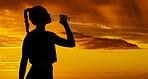 Shadow, sunset and silhouette woman drinking water for marathon running, fitness exercise and hiking workout on outdoor orange sky. Healthy, thirsty and sports athlete drink bottle for wellness rest