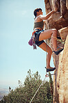 Mountain, climbing and sport with a sports woman or athlete abseiling outdoor for health and fitness. Training, workout and exercise with a young female athlete or climber scaling a rocky cliff