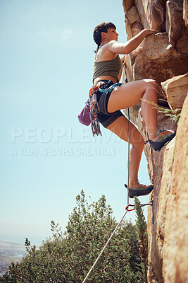 Buy stock photo Mountain, climbing and sport with a sports woman or athlete abseiling outdoor for health and fitness. Training, workout and exercise with a young female athlete or climber scaling a rocky cliff