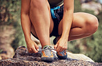 Outdoor runner, tie fitness shoes and sports woman start cardio workout in los angeles forest. Athlete ready to exercise, training for trail running distance and active healthy lifestyle motivation