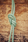 Safety, security and mountain climbing rope knot for helping on outdoor or outside strong rock challenge fall risk danger. Fitness, exercise and training equipment gear for workout or wall adventure