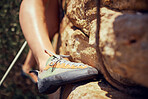 Woman, feet or rock climbing shoes in fitness, workout or training on mountains in nature landscape environment. Zoom, texture or legs of hiking athlete in health, freedom or sports exercise in Spain