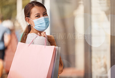 Buy stock photo Shopping, medical mask and portrait of woman with shopping bags, smile or happy with sale luxury designer clothes. Rich customer, retail and Asian girl with discount, fashion or store sales in street