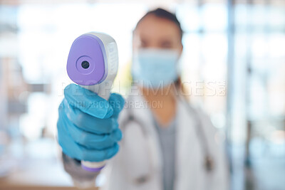 Buy stock photo Hand, woman doctor and covid test thermometer laser gun for medical exam, check or covid 19 scan at vaccine center. Healthcare nurse, mask and glove for corona virus safety and protection at clinic

