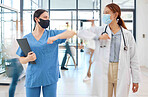 Covid healthcare doctor and nurse women with elbow gesture in hospital clinic. Medical expert people with face mask and social distancing in corona virus pandemic for trust, motivation and innovation