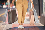 Walking woman in city with retail shopping bag, discount sales and market service deals. Closeup of rich customer, consumer spending and wealthy female person in street outdoors buying luxury fashion