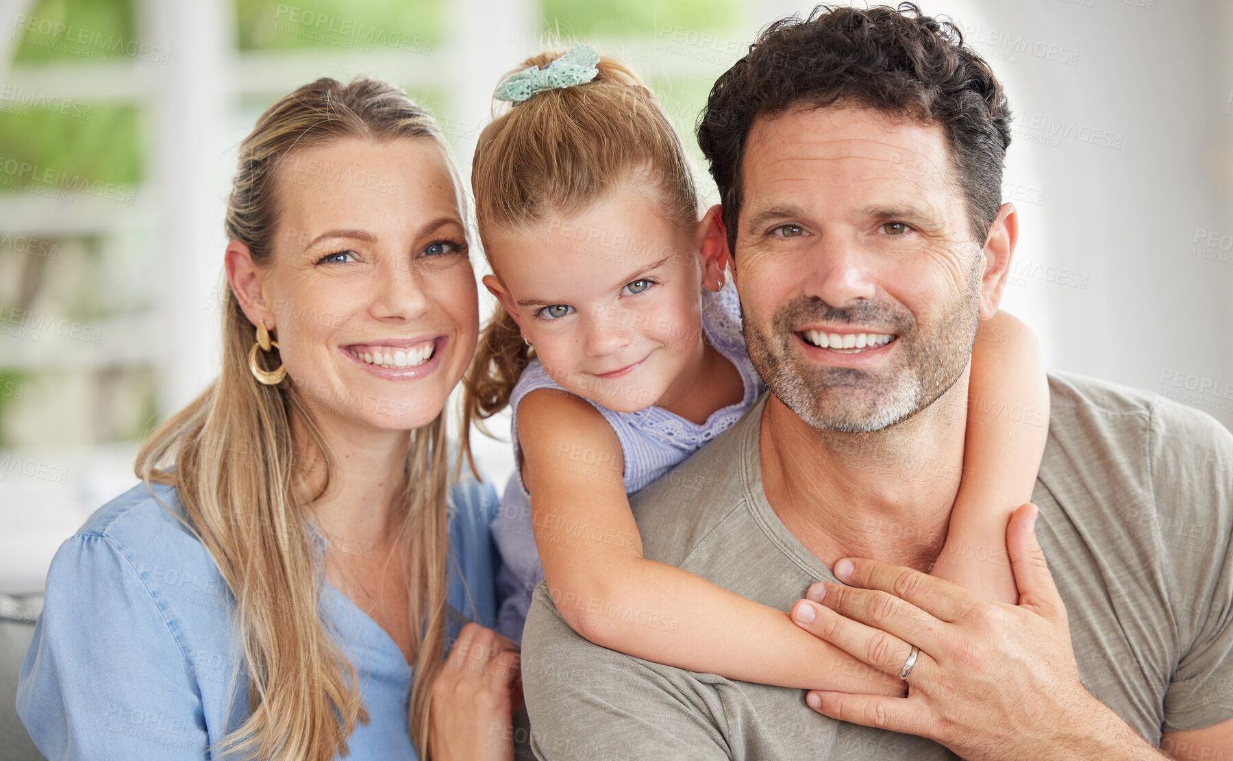 Buy stock photo Happy family, portrait and bonding on a sofa with girl relaxing with her parents in their home. Man and woman enjoying quality time with daughter indoors, cheerful and relax in their house together