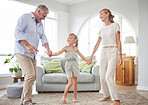 Love, retirement and family dancing in home living room together to bond with cute girl child. Happy senior grandmother and grandfather enjoy fun in family home with young grandchild.

