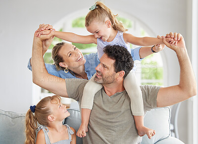 Buy stock photo Happy family, play and bonding on a sofa in their home, cheerful and having fun. Young parents being playful and loving with their girls, enjoying a game on the weekend with fun mother and father