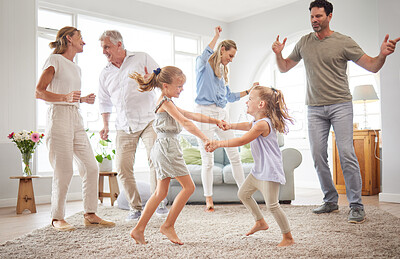 Buy stock photo Happy, dance and love with big family in living room together for crazy, energy and excited. Lifestyle, freedom and celebration dancing at modern home with parents, children and grandparents