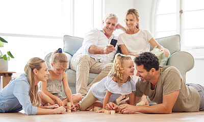 Buy stock photo Happy family, relax and play in a living room, bonding and and talking on a floor together. Grandparents resting on a sofa, taking picture on a phone of his family playing and laughing at home
