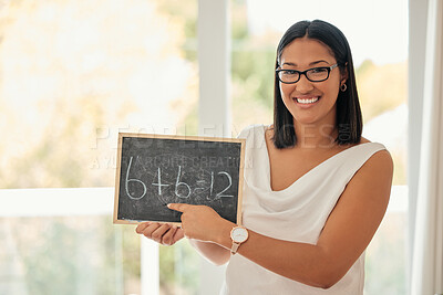 Buy stock photo Happy, smile and portrait of a math teacher with a board pointing to an equation in her classroom. Happiness, smart and young woman standing in a primary school teaching mathematics with a chalkboard