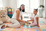 Mother, child and home of a knowledge growth and house education toy together in a bedroom. Portrait of a happy family with a smile play a education game to build balance and children motor skills