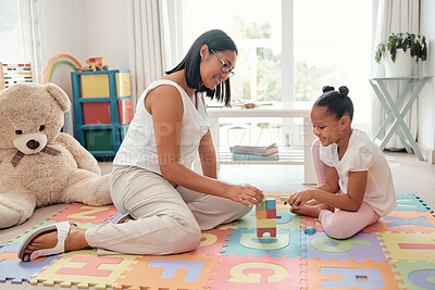 Buy stock photo Teaching game, building toys and mother with girl in kid bedroom for growth, knowledge and problem solving. Mom, child or black people together on a floor for mental thinking development and learning