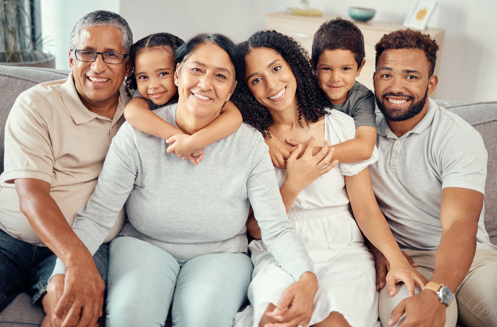 Buy stock photo Big family, home and happy smile on a living room lounge sofa together with happiness and love. Portrait of grandparent, mother and children from Mexico smiling on a house couch with a hug from kids