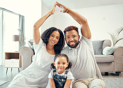 Buy stock photo Protection, smile and portrait of family with a roof or covering hand gesture sitting on the living room floor. Happy, safety and home insurance of parents with girl child at a modern home together.