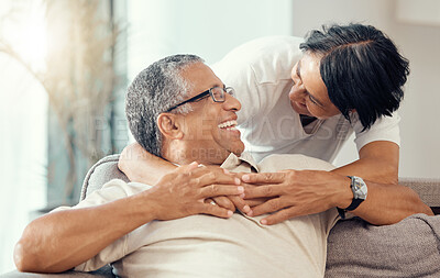 Buy stock photo Love, senior couple and hug while laughing, bonding and sharing a romantic moment during retirement on the sofa at home. Joy, commitment and healthy relationship of an elderly man and woman together