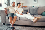 Mature couple relax with laptop on sofa, bond, laugh and streaming a funny online video in a living room. Elderly man and woman looking happy and cheerful, enjoying retirement and peaceful lifestyle