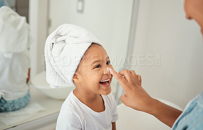 Buy stock photo Skincare, cream and girl child at home with mother with a happy smile in a bathroom. Happiness of a kid and mom using face lotion, skin wellness and youth morning beauty routine at a family house