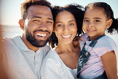 Buy stock photo Happy, black family and smile for beach selfie in happiness together on a summer vacation in the outdoors. Portrait of a African man and woman holding little girl smiling for bonding love and care