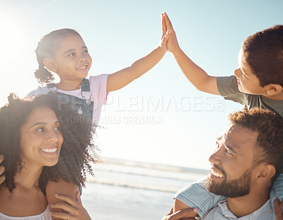 Buy stock photo High five, kids and parents at the beach on vacation, holiday and enjoying the sunny day. Family, father and mother on a day outside by ocean with the children on the backs, playing and smile.