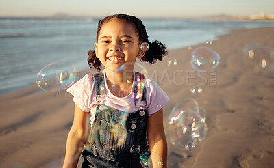 Buy stock photo Beach, bubbles and a girl playing at sunset, having fun and enjoying an ocean trip. Freedom, energy and child running alone the sea, excited and playful while chasing bubble and laughing in nature