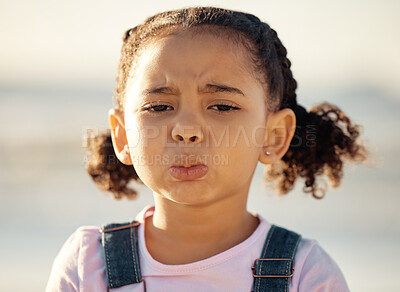 Buy stock photo Portrait, sad and face of an unhappy little girl feeling lonely or upset against a blurred background. Closeup of an emotional African female child with depressed facial expression for end of summer