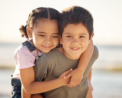 Buy stock photo Children, kids and outdoor hug of boy and girl with a happiness in nature. Portrait of a happy smile of a young cute kid and child siblings smiling by the sea, ocean and beach hugging youth together 