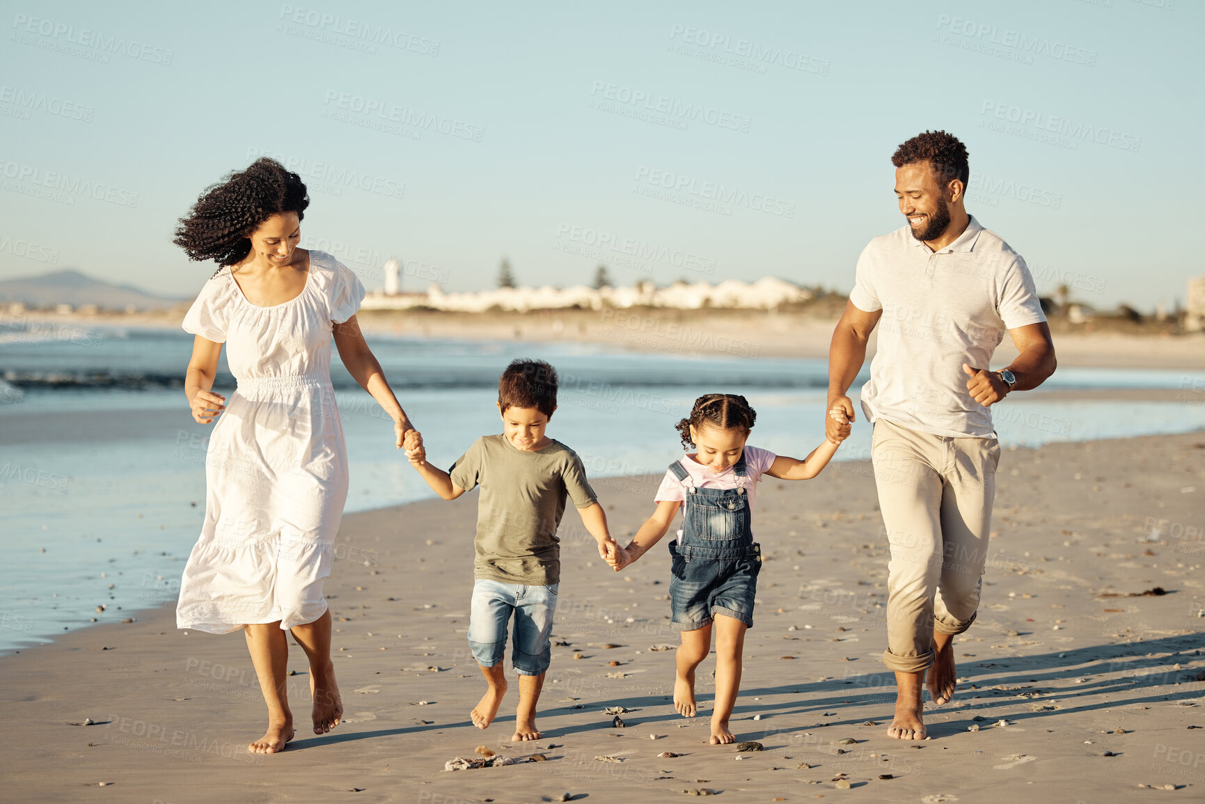 Buy stock photo Happy family, beach and family bonding while walking and laughing at sunset, cheerful and relaxed. Fun parents sharing playful activity with their children, enjoying parenthood and walk along ocean