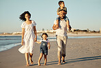 Travel, freedom and happy family at the beach, walking and bonding on ocean trip together. Portrait of loving parents enjoying fun getaway with their children, caring and playing on a walk at sunset