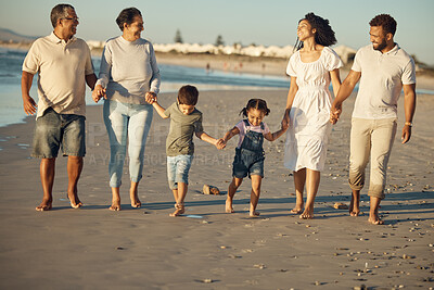 Buy stock photo Big family walking on the beach together with grandparents, children and mom, dad for wellness, exercise and healthy lifestyle. Retirement couple and people with children for outdoor fun in summer