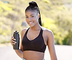 Fitness, health and sports with black woman and bottle for running, exercise or training in the outdoor. Motivation, workout and water with portrait of young girl or runner in nature for wellness