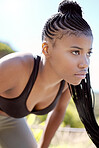 Motivation, focus and fitness black woman about to run a sport workout outdoor. Sports training, health exercise and athlete with a serious face expression about to start a strong cardio session