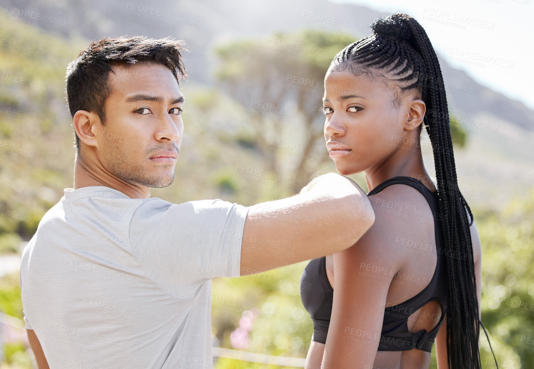 Buy stock photo Fitness, challenge and couple ready for exercise, running and workout on a mountain together in nature. Interracial, sports portrait and healthy black woman training with personal trainer or partner 