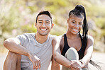 Portrait of happy and diverse couple bonding after a morning run, relax and rest while sitting outside. Smiling woman enjoying a healthy lifestyle with asian boyfriend, cheerful and carefree