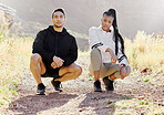 Interracial couple, fitness and nature in sports motivation and fashion for healthy outdoor exercise or workout. Portrait of fit confident asian man and black woman crouching on hiking trail outdoors