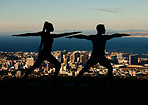 Yoga, silhouette and city with a woman and man outdoor for exercise, workout and training. Health, wellness and fitness with a couple exercising outside together on an urban background in the evening