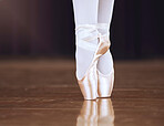 Ballet, dance and shoes with the feet of a ballerina or dancer dancing on a theater stage for a performance or show. Creative, art and training with an artist or performer practicing for a rehearsal