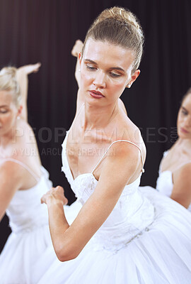 Buy stock photo Ballet, dance and art with a woman ballerina or dancer dancing on a theater stage during a performance. Creative, artistic and movement with a female artist or performer group training for a recital