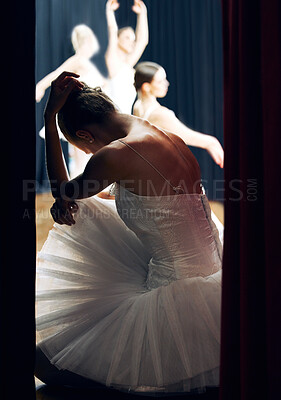 Buy stock photo Dancer thinking backstage at ballet concert or recital while group on theater stage. Girl ballerina waiting on floor of auditorium, anxiety and nerves, for performance in front of audience or crowd