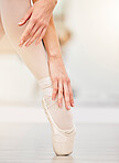 Ballet, dance and shoes of woman on studio floor stretching for art, class and fitness. Creative, training and motivation with foot of ballerina dancer in performance, dancing and commitment 
