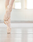 Professional ballet dancer woman feet in dance studio, art school or creative academy with mock up or copy space. Young student balance on pointe shoes dancing in training class for performance