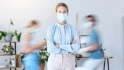 Buy stock photo Business woman with his arms crossed and covid mask for safety at work in a busy office. Portrait of female manager with facial cover protection from a virus and covid 19 for healthcare and wellness