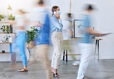 Buy stock photo Covid, office and woman on phone call standing with face mask around work colleagues in motion blur. Female employee on mobile smartphone calling in a busy workplace of fast business people walking