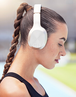 Buy stock photo Woman runner listening to music on headphones training for fitness marathon or triathlon streaming radio audio. Girl sports athlete workout, running and mp3 song exercise for cardio at track stadium