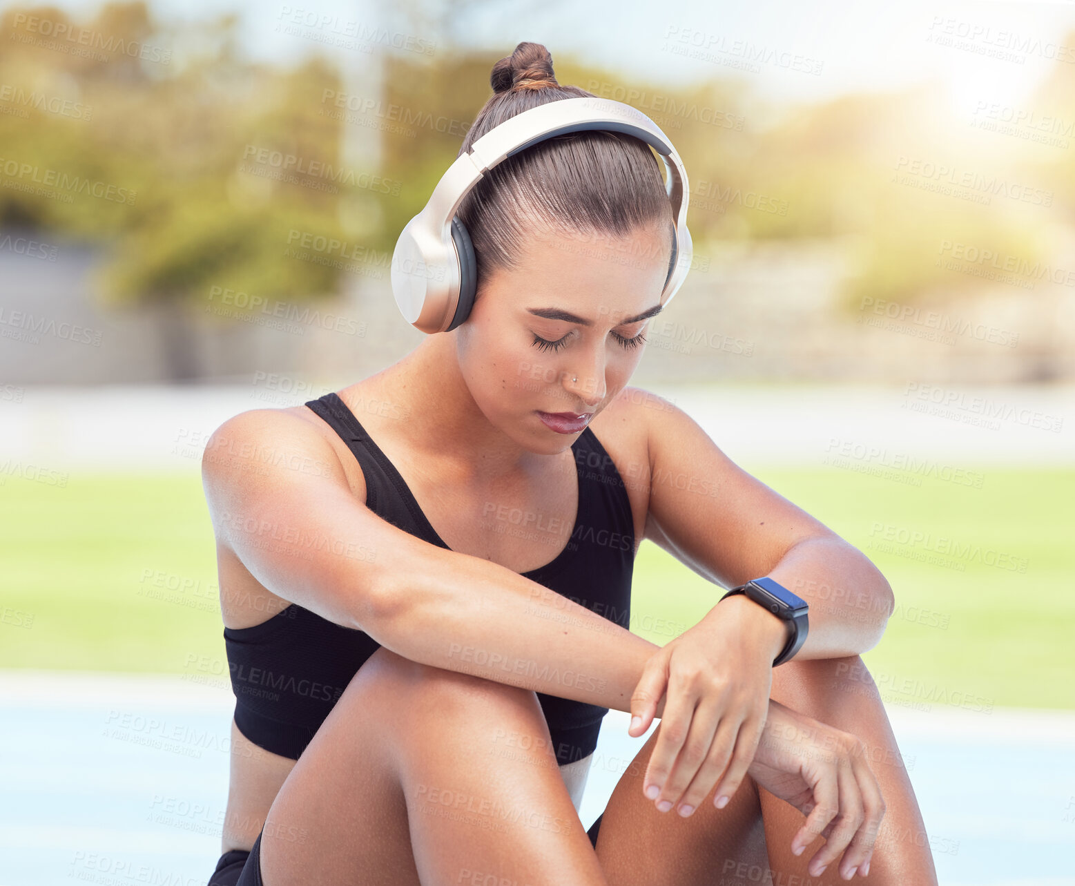 Buy stock photo Sport runner woman listening to music on break from training, exercise and fitness workout. Tired athlete rest to recover from pain, prevent muscle injury and physical exhaustion or medical emergency