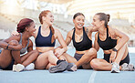 Happy, diversity and sports women, friends and athletes break from marathon training workout on running track at stadium arena outdoors. Smile, healthy and fitness group rest, motivation and support
