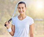 Portrait of tennis woman at the tennis court with a smile on her face. Young female doing sports, having fun and ready for a game with tennis racket.  Fitness, motivation and smiling tennis player