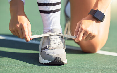 Buy stock photo Tennis player tie shoes before a game on the tennis court, ready to win. Female sports player tying shoelace on sneakers before tennis match. Training, exercise and having fun playing sport outdoors